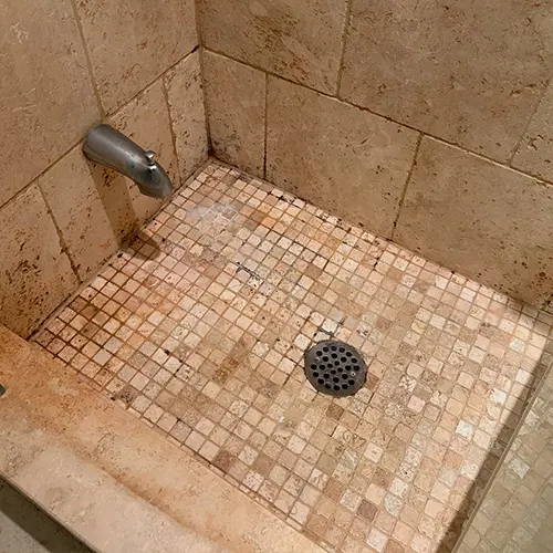 Shower floor tile and grout before restoration